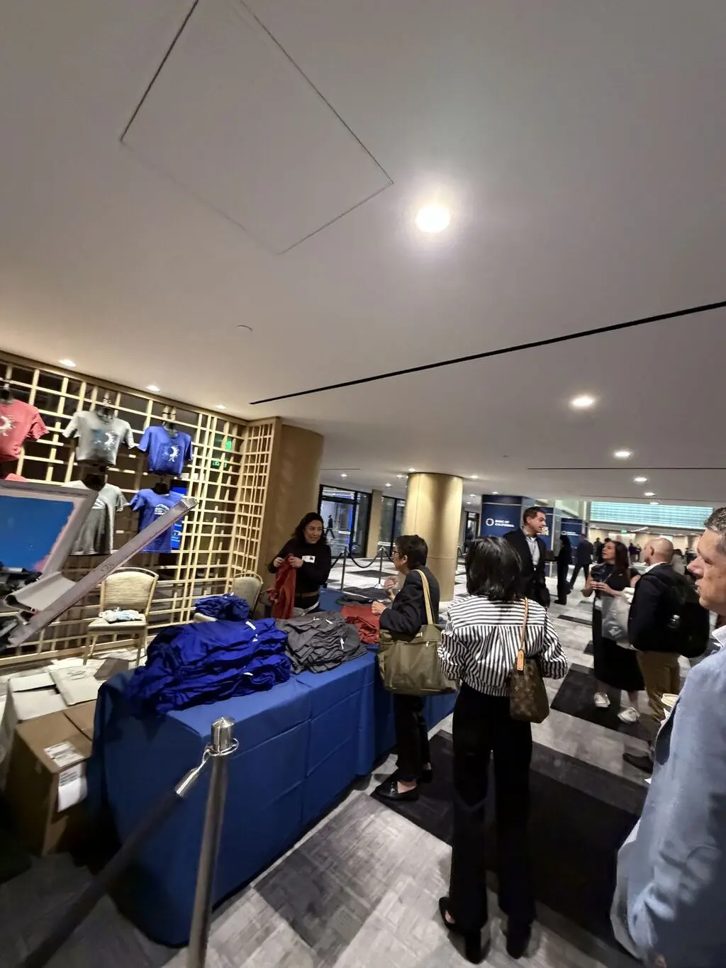 Guests choosing apparel at an event merch station