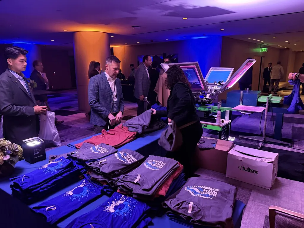 Guests choosing shirts at a live printing station during an event