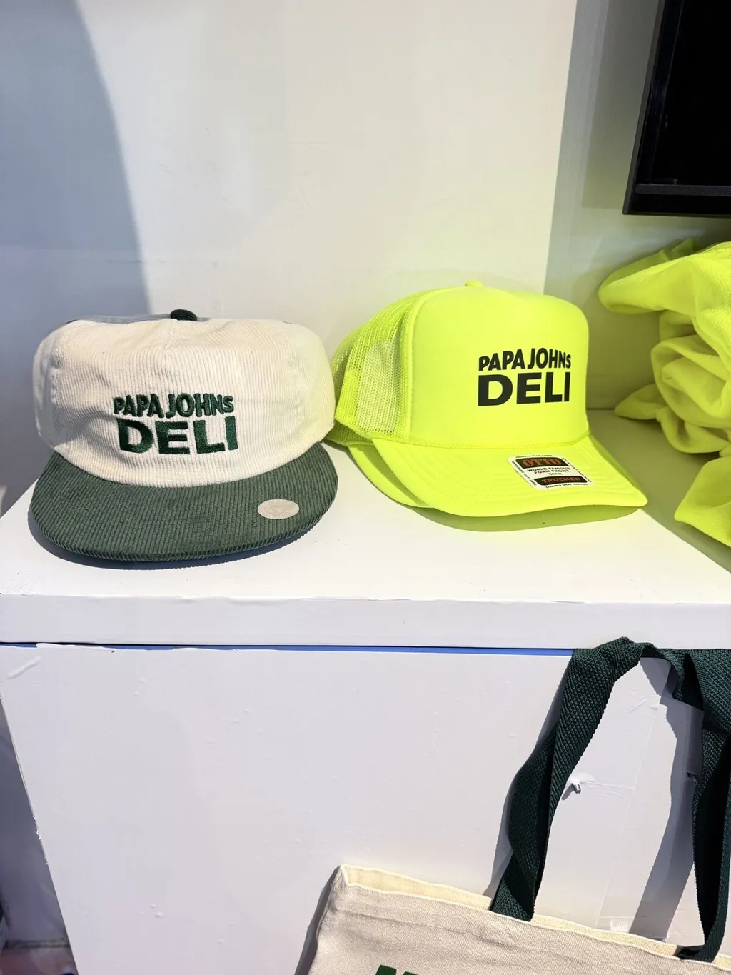 Papa John’s Deli branded hats on display at a pop-up